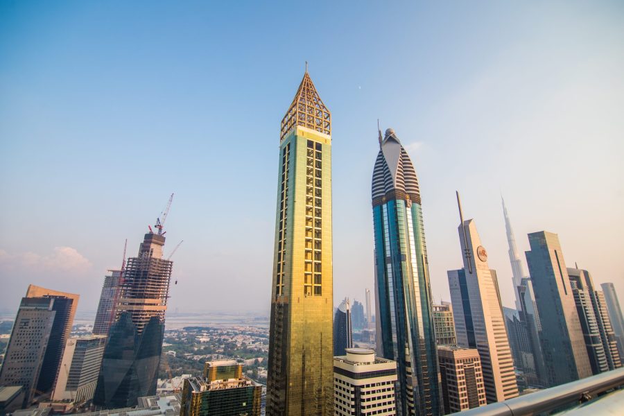Scenic aerial view downtown Dubai, United Arab Emirates with skyscrapers and highways. Colourful travel background.